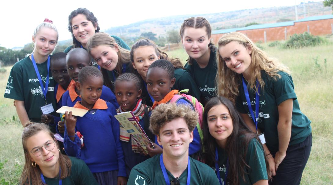 Volunteers take a picture with the school children in Kenya. High School volunteer take a picture with the beneficiaries of their Childcare Project in Kenya.